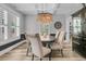 Elegant dining room features a stunning chandelier, wainscoting, and a view into the butler's pantry at 1245 Saddlehorn Rd, Summerville, SC 29486