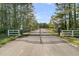 Image of a metal and white fencing gate entrance leading into the property at 1245 Saddlehorn Rd, Summerville, SC 29486