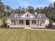 Inviting exterior view of a home with a covered porch, columns, and well-manicured lawn at 1245 Saddlehorn Rd, Summerville, SC 29486