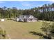 Sprawling front yard of a home with a large porch, columns, and a well-manicured lawn at 1245 Saddlehorn Rd, Summerville, SC 29486
