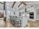 Spacious white kitchen with island seating, stainless steel appliances, and wooden beam accents at 1245 Saddlehorn Rd, Summerville, SC 29486