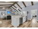 Open-concept kitchen with island, stainless steel appliances, and wooden beams, connecting to the living area at 1245 Saddlehorn Rd, Summerville, SC 29486