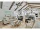 Spacious living room featuring exposed beams, hardwood floors, and an open layout to the kitchen at 1245 Saddlehorn Rd, Summerville, SC 29486