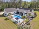An aerial view of a stunning home showcasing a beautiful pool surrounded by lush landscaping and a black aluminum fence at 1245 Saddlehorn Rd, Summerville, SC 29486