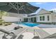 Backyard oasis with a refreshing pool, lounge chairs, and a shaded umbrella at 1245 Saddlehorn Rd, Summerville, SC 29486