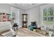 Versatile room with wood-look floors and natural light, filled with moving boxes, furniture, and household goods at 1245 Saddlehorn Rd, Summerville, SC 29486