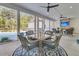 Inviting screened porch with dining area and stone fireplace overlooking pool at 1245 Saddlehorn Rd, Summerville, SC 29486