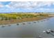Expansive aerial view showcasing waterfront property with multiple docks and boat access to the Charleston harbor at 13 Broughton Rd, Charleston, SC 29407
