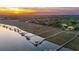 Aerial view featuring private boat docks, marsh, and a waterfront home at 13 Broughton Rd, Charleston, SC 29407