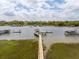 Scenic aerial view highlighting a private dock with boat lift and covered seating, providing direct access to the open water at 13 Broughton Rd, Charleston, SC 29407