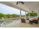 Inviting back porch with rocking chairs overlooking a pool and picturesque waterfront at 13 Broughton Rd, Charleston, SC 29407