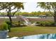 Picturesque backyard with inviting seating around a fire pit, set against the backdrop of a tranquil waterfront and dock at 13 Broughton Rd, Charleston, SC 29407