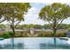 Infinity pool with a view overlooking a serene waterfront setting, enhancing the tranquil backyard retreat at 13 Broughton Rd, Charleston, SC 29407