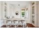 Stylish bar area featuring granite counters, a window view, and barstool seating at 13 Broughton Rd, Charleston, SC 29407