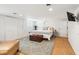 Finished basement bedroom boasts a comfortable bed, wooden chest, plush rug, and a wall-mounted television at 13 Broughton Rd, Charleston, SC 29407
