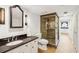 Bathroom features a granite vanity, tiled shower, and storage in an adjacent room with a unique round window at 13 Broughton Rd, Charleston, SC 29407