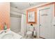 Charming bathroom featuring patterned wallpaper, a crystal chandelier, and a shower with white subway tile surround at 13 Broughton Rd, Charleston, SC 29407