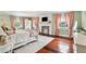 Bedroom showcasing fireplace, chandelier, hardwood floors, and natural light from two windows at 13 Broughton Rd, Charleston, SC 29407