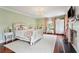 Bedroom featuring hardwood floors, fireplace, chandelier and two windows at 13 Broughton Rd, Charleston, SC 29407