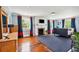 Spacious bedroom with hardwood floors, fireplace, blue rug and lots of natural light from several windows at 13 Broughton Rd, Charleston, SC 29407