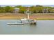 Waterfront property with private dock featuring a boat lift and covered seating area, perfect for enjoying the scenic views at 13 Broughton Rd, Charleston, SC 29407