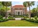 A beautiful brick home boasts symmetrical staircases, mature landscaping, and a classic architectural style at 13 Broughton Rd, Charleston, SC 29407