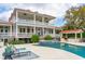 Stately home with outdoor kitchen, pool, and lounge chairs at 13 Broughton Rd, Charleston, SC 29407