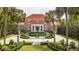A brick home with a red roof features elegant staircases, palm trees, and manicured landscaping for curb appeal at 13 Broughton Rd, Charleston, SC 29407