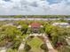 Aerial shot featuring a grand home with lush landscaping and private docks on a serene waterfront setting at 13 Broughton Rd, Charleston, SC 29407