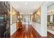 Elegant foyer features gleaming hardwood floors, decorative wallpaper, and ornate lighting for a grand entrance at 13 Broughton Rd, Charleston, SC 29407