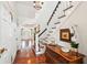 Elegant foyer featuring dark wood floors, staircase with white railings, and chandelier at 13 Broughton Rd, Charleston, SC 29407
