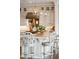 Elegant kitchen island with pendant lights, countertops, and decorative chairs at 13 Broughton Rd, Charleston, SC 29407