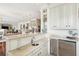 Open kitchen with granite counters, small sink and wine cooler with clear view to dining and living area at 13 Broughton Rd, Charleston, SC 29407