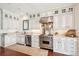 Modern kitchen with stainless steel appliances, white cabinets, and wooden floor at 13 Broughton Rd, Charleston, SC 29407