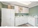 Bright laundry room featuring white cabinets and lots of counter space at 13 Broughton Rd, Charleston, SC 29407