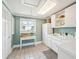 Bright laundry room with white cabinets, sink, and view from window at 13 Broughton Rd, Charleston, SC 29407