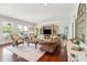 Spacious living room with hardwood floors, built-in media center, and access to a screened porch at 13 Broughton Rd, Charleston, SC 29407