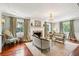 Bright living room with hardwood floors, fireplace, chandelier, and elegant furnishings at 13 Broughton Rd, Charleston, SC 29407