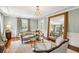 Bright living room with hardwood floors, fireplace, chandelier, large mirror, and elegant furnishings at 13 Broughton Rd, Charleston, SC 29407