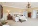 Elegant main bedroom featuring a chandelier, decorative furniture, and a view to a bathroom entrance at 13 Broughton Rd, Charleston, SC 29407