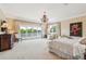 Spacious main bedroom with a chandelier, balcony access, and neutral decor at 13 Broughton Rd, Charleston, SC 29407