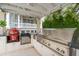 Outdoor kitchen with built-in grill and stainless steel appliances at 13 Broughton Rd, Charleston, SC 29407
