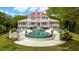 An extravagant two-story home boasts a stunning backyard pool with lounge chairs and a bar area for outdoor entertaining at 13 Broughton Rd, Charleston, SC 29407