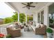 Inviting porch with wicker furniture and patterned rug, perfect for outdoor relaxation at 13 Broughton Rd, Charleston, SC 29407