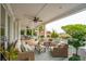 Spacious covered porch featuring comfortable seating and views of lush greenery at 13 Broughton Rd, Charleston, SC 29407
