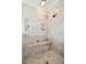 Elegant marble shower with bench and rainfall shower head at 13 Broughton Rd, Charleston, SC 29407