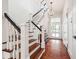 Elegant staircase featuring dark wood treads, white risers, and decorative chandelier at 13 Broughton Rd, Charleston, SC 29407