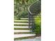 Elegant outdoor staircase with wrought iron railing and greenery, showcasing the home's charming architectural details at 13 Broughton Rd, Charleston, SC 29407