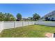 Private fenced backyard with green grass and views of neighboring townhomes at 132 Lynches River Dr, Summerville, SC 29485
