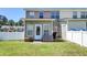A cozy backyard with a white fence and patio, perfect for relaxing and grilling at 132 Lynches River Dr, Summerville, SC 29485
